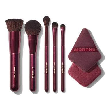 Set of Morphe makeup brushes and a sponge on a white background